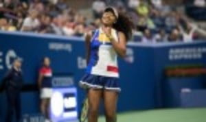 Naomi Osaka grabbed the headlines on a rain-interrupted day two of the US Open as she blasted her way past the defending champion Angelique Kerber 6-3 6-1 in just 64 minutes