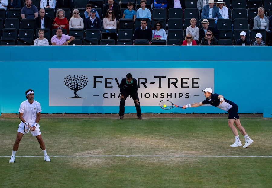 Andy Murray dives to return during doubles match at Queens