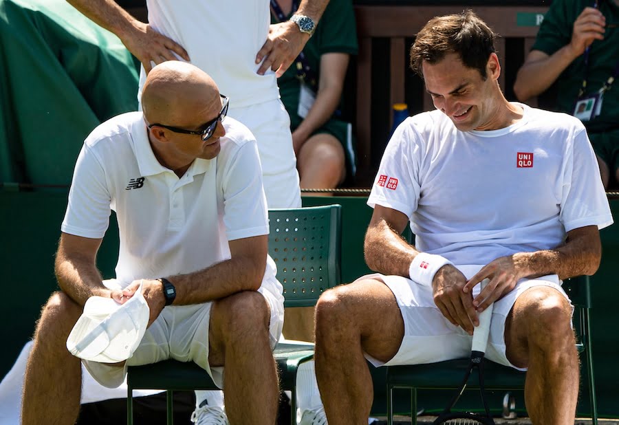 Federer laughs during practise at Wimbledon 2019