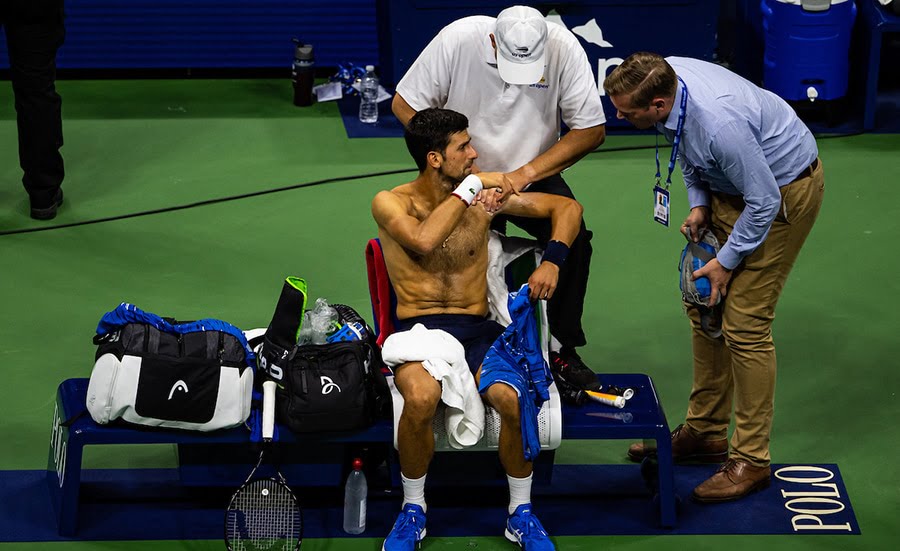 Novak Djokovic receiving treatment