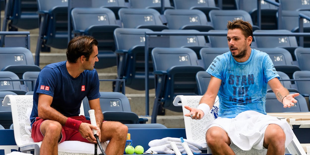 Roger Federer chats with Stan Wawrinka at practise