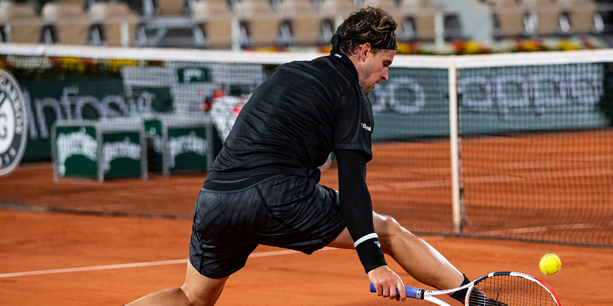 Dominic Thiem stoops at the net