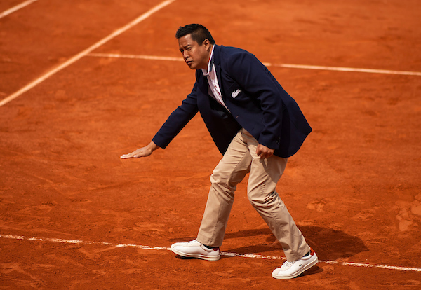 The umpire James Keothavong checks a ball mark at the French Open